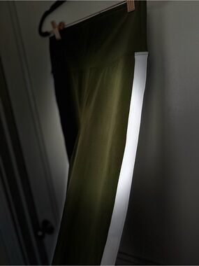 Zyia 7/8 legging in green with white stripe.